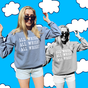 Field Daze founder poses with her arms up wearing Villanova Basketball Coach Jay Wright inspired crewneck sweatshirt that reads "All Wright All Wright All Wright"